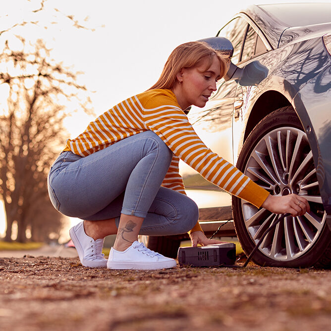 Woman Inflating Car Tire Woman Inflating Car Tire